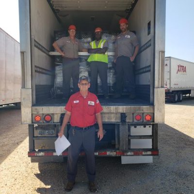 Borden employees prepare to send off the third truck full of beverages for World Central Kitchen. Pictured from left to right are Dothan, Ala. employees Glynn Brown, Leonard Ward and Brian Garrard. Pictured on the ground is Tony Owens.